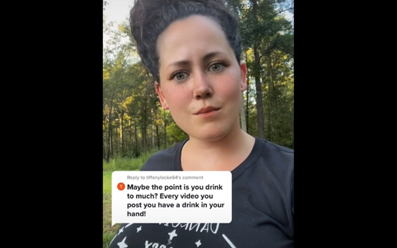 Jenelle drinks wine